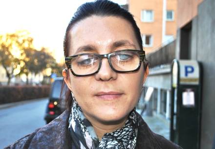 Senija Okić har mörkt hår och glasögon.
